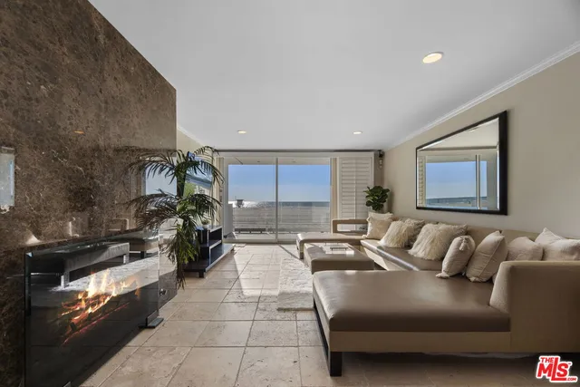 a view of a white building among the street and palm trees