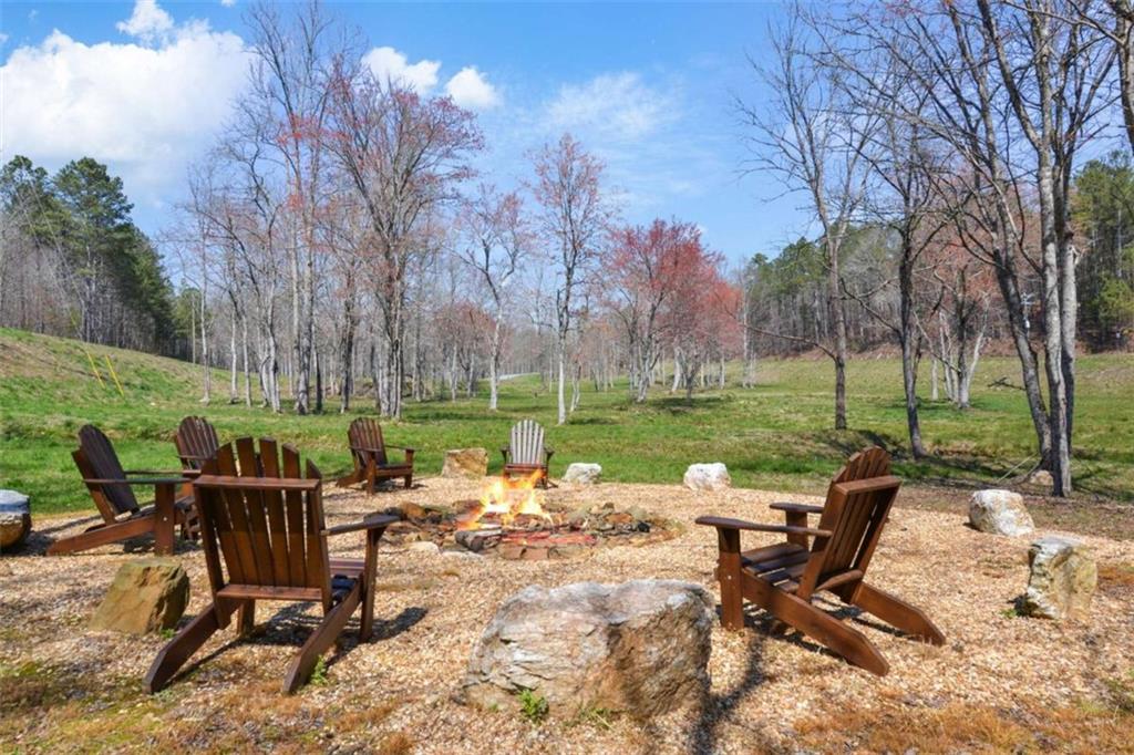 285 Anglers Ridge Road Talking Rock, GA 30175 - Photo 25 of 31 a view of a chairs and table in backyard of the house