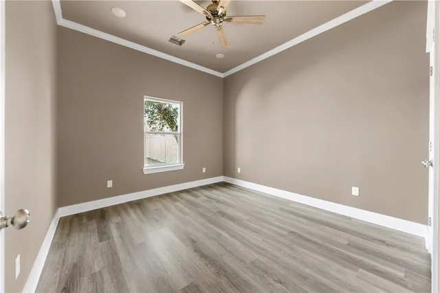 a view of a kitchen with wooden floor and windows