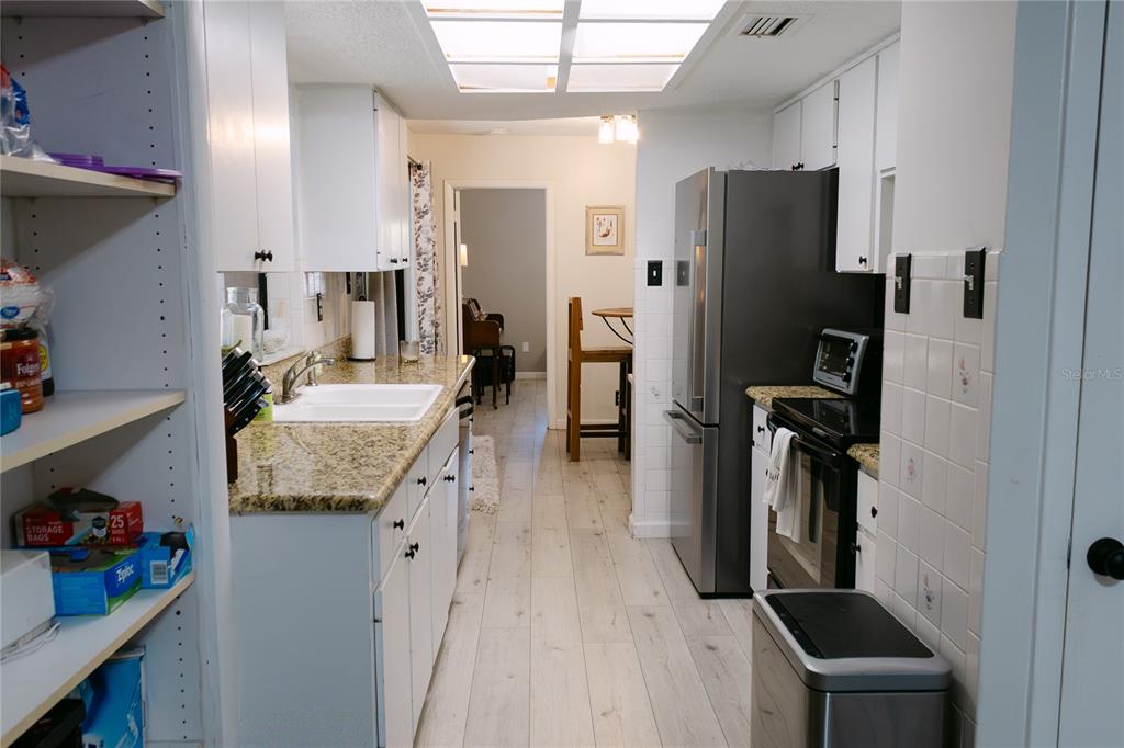 18305 Oakdale Road Odessa, FL 33556 - Photo 13 of 42 a kitchen with refrigerator and countertop