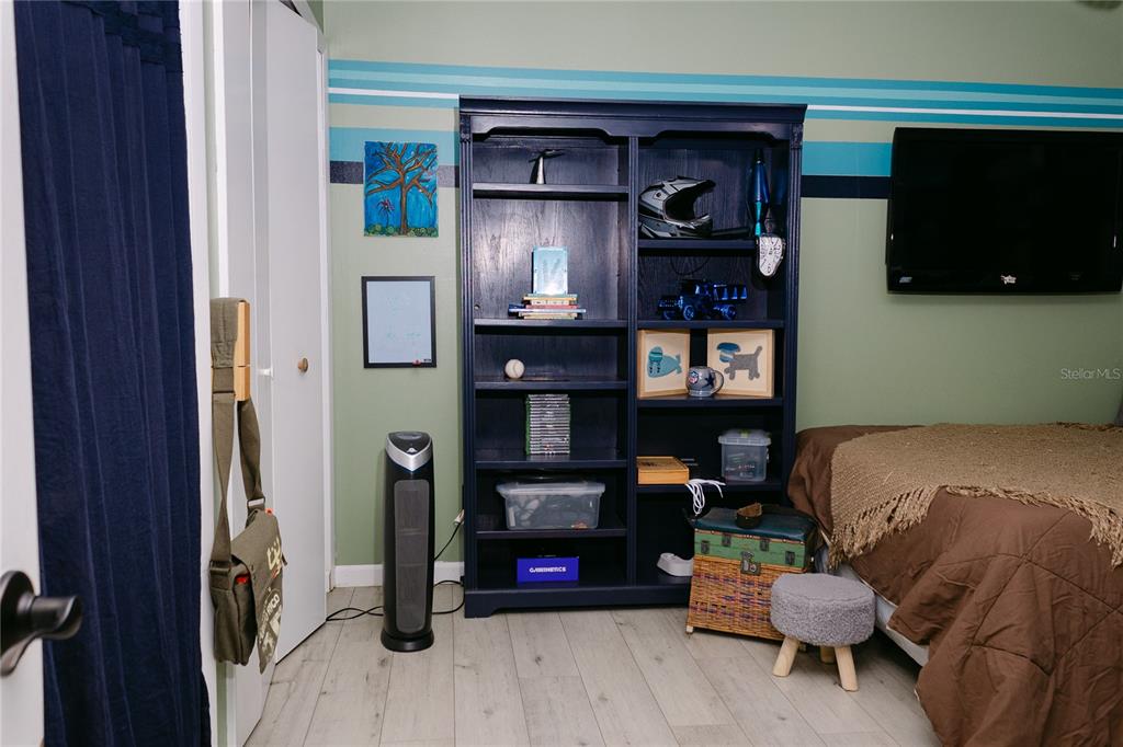 18305 Oakdale Road Odessa, FL 33556 - Photo 26 of 42 a bedroom with a bed and a television