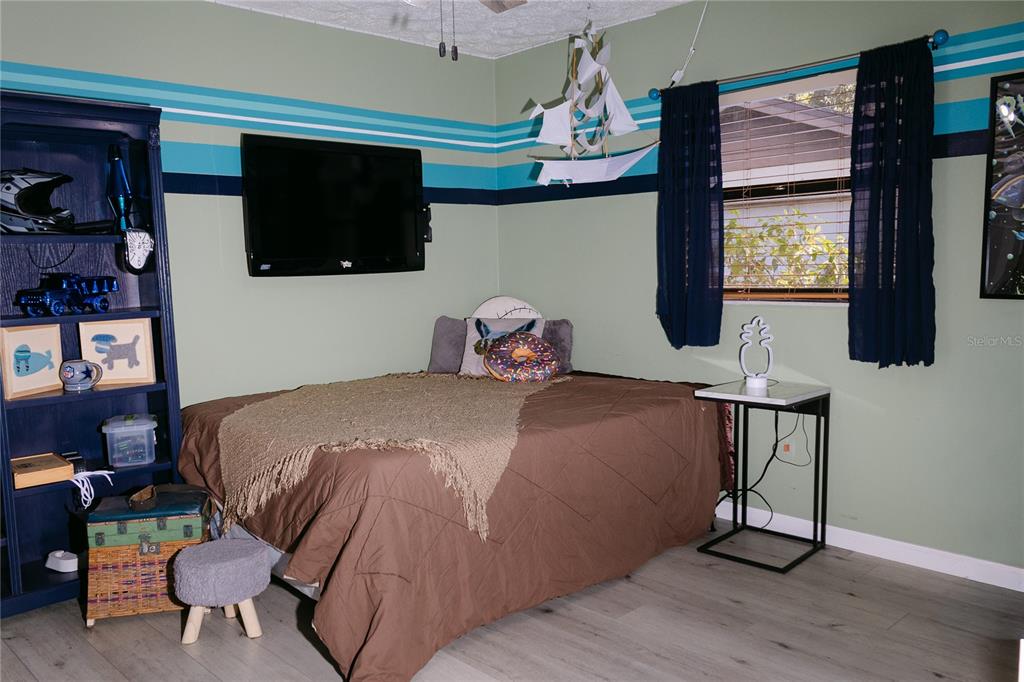 18305 Oakdale Road Odessa, FL 33556 - Photo 28 of 42 a bedroom with a bed and flat screen tv