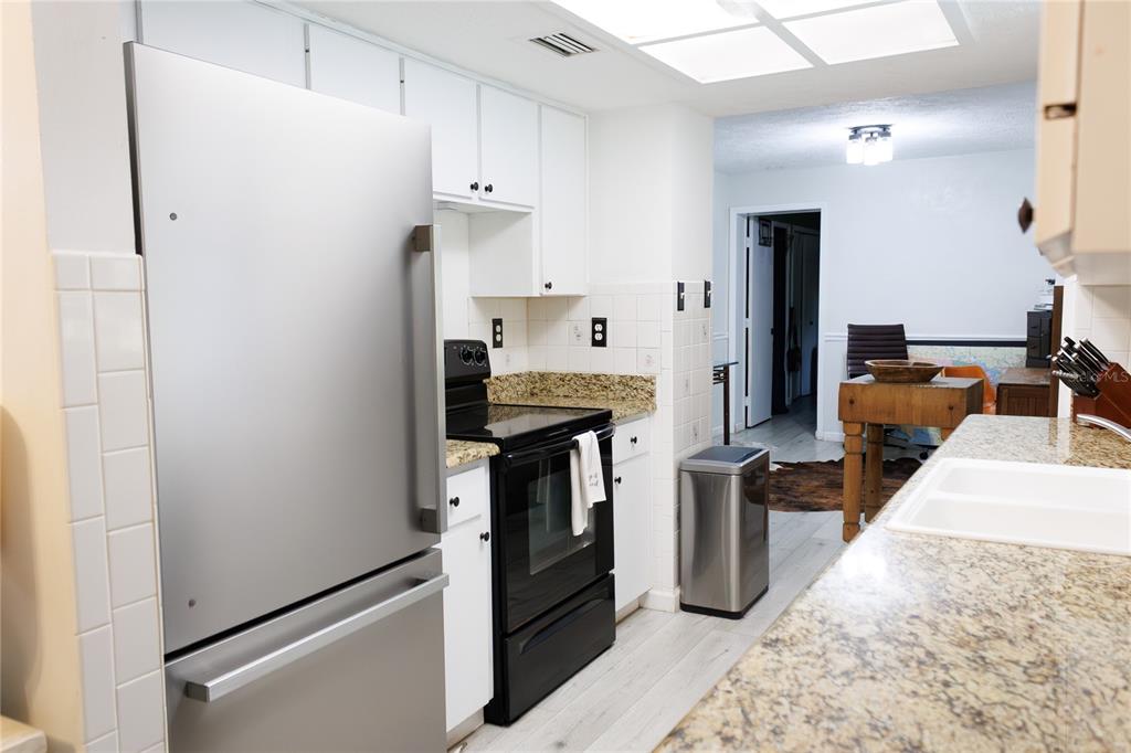 18305 Oakdale Road Odessa, FL 33556 - Photo 10 of 42 a kitchen with stainless steel appliances a refrigerator sink and stove