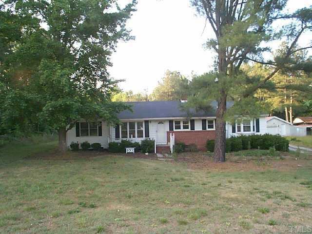 491 Highway 56 Louisburg, NC 27549 - Photo 1 of 1 a front view of a house with a garden