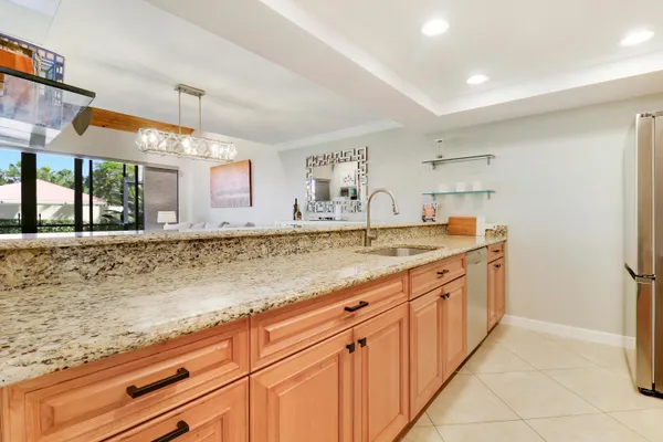 a kitchen with stainless steel appliances granite countertop a sink and a stove