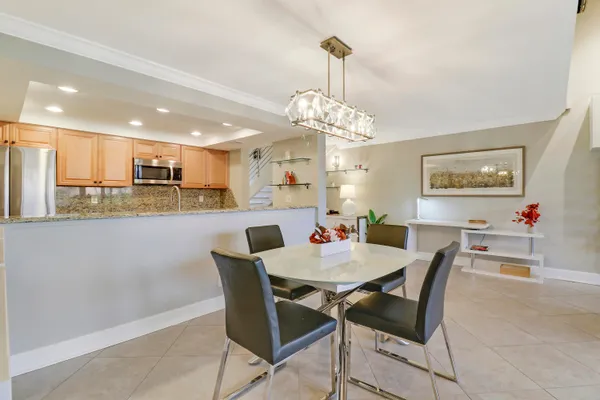 a view of a dining room and a kitchen with a dining table chairs