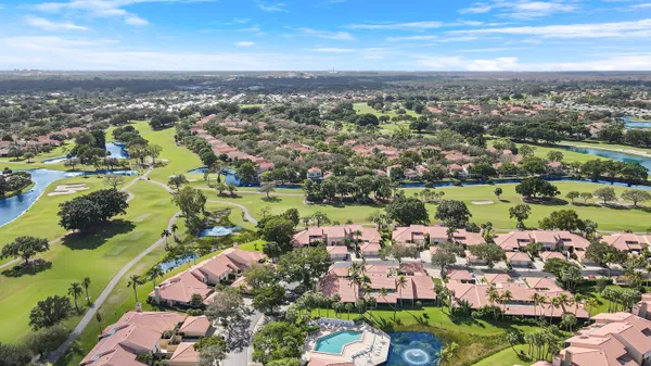 an aerial view of a city with lots of residential buildings lake and ocean view