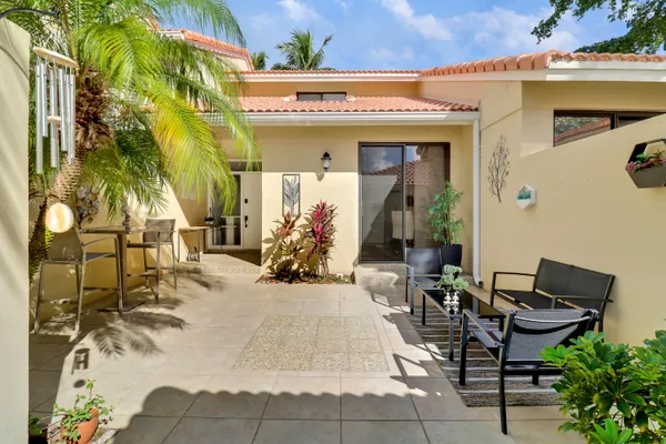 a view of a patio with table and chairs and potted plants