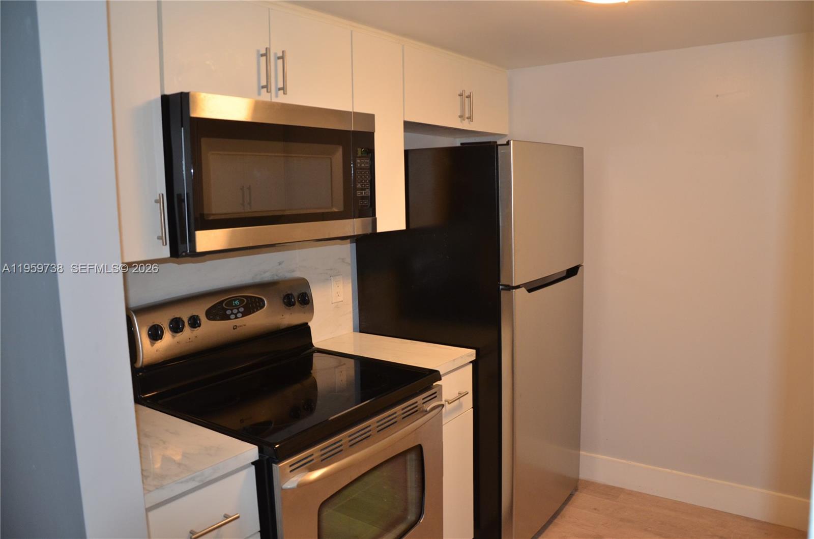 13475 Southwest 9th Street, Unit 407A Pembroke Pines, FL 33027 - Photo 11 of 15 a kitchen with a stove microwave and refrigerator