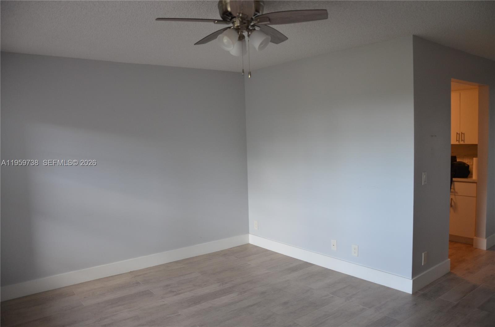 13475 Southwest 9th Street, Unit 407A Pembroke Pines, FL 33027 - Photo 12 of 15 an empty room and a chandelier fan