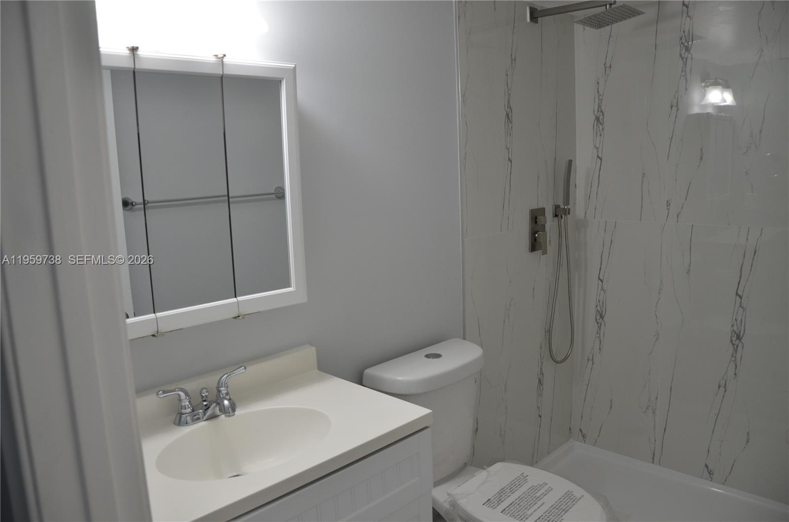 13475 Southwest 9th Street, Unit 407A Pembroke Pines, FL 33027 - Photo 6 of 15 a bathroom with a sink a toilet and shower