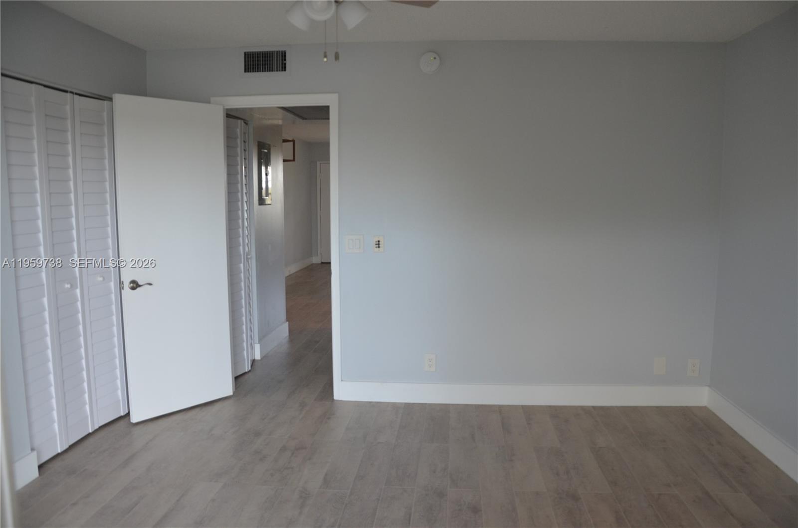 13475 Southwest 9th Street, Unit 407A Pembroke Pines, FL 33027 - Photo 8 of 15 a view of an empty room with wooden floor and closet