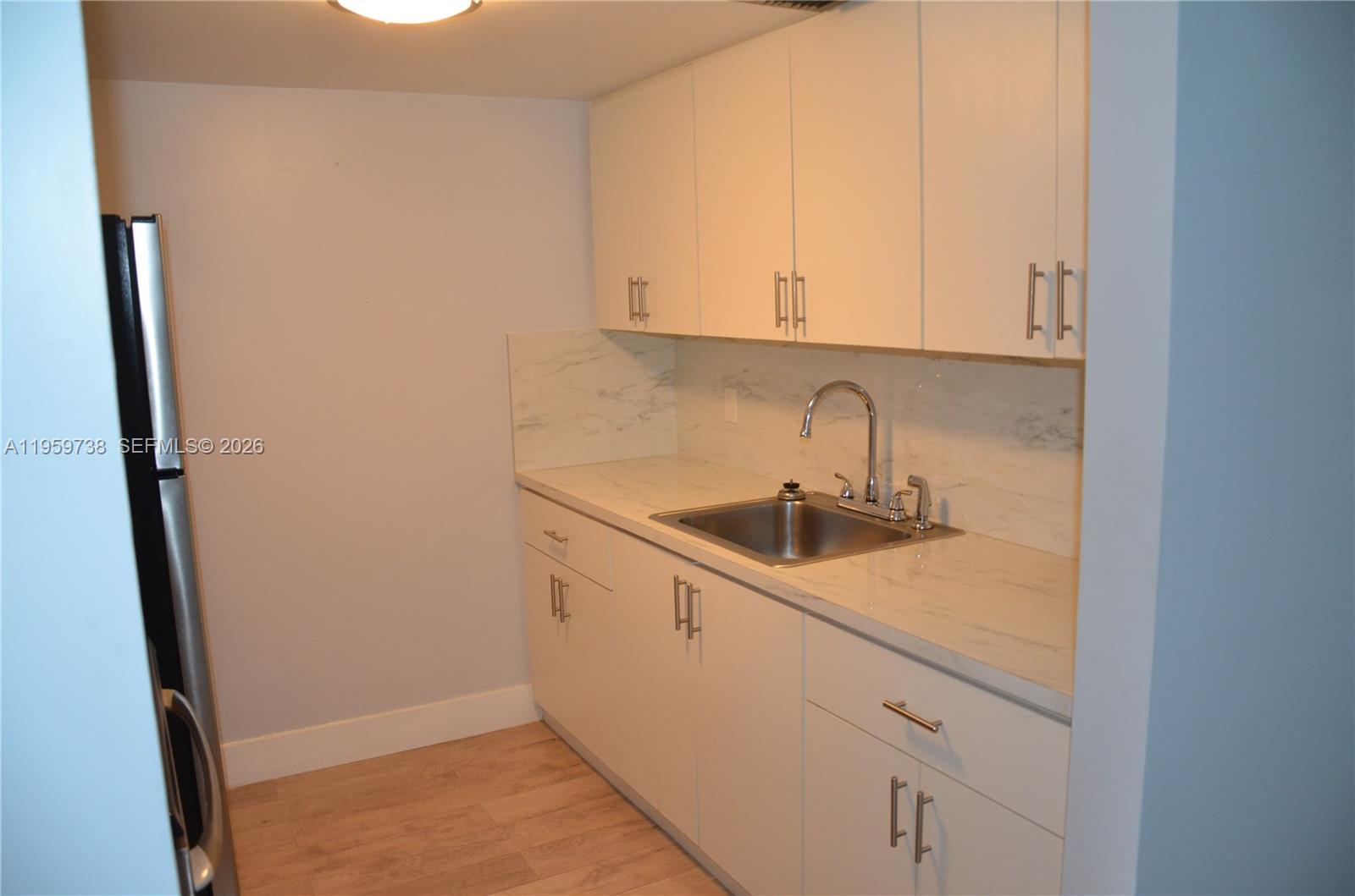 13475 Southwest 9th Street, Unit 407A Pembroke Pines, FL 33027 - Photo 10 of 15 a kitchen with a sink and cabinets