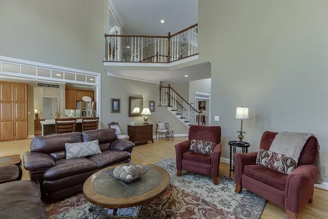 a kitchen with a stove a sink dishwasher a dining table and chairs with wooden floor