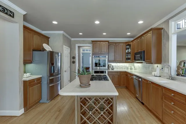 a view of a dining room with furniture wooden floor and chandelier