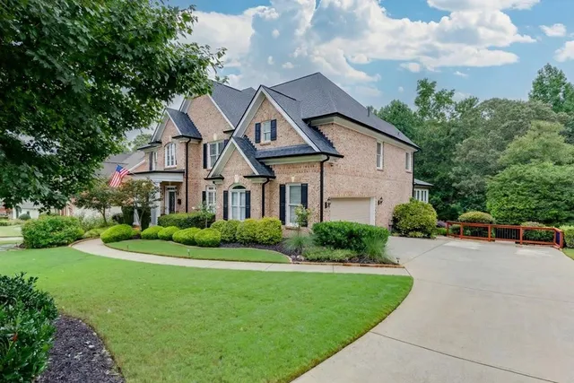 a front view of a house with a yard table and chairs