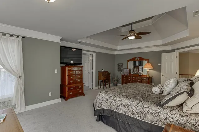 a front view of a house with a garden and plants