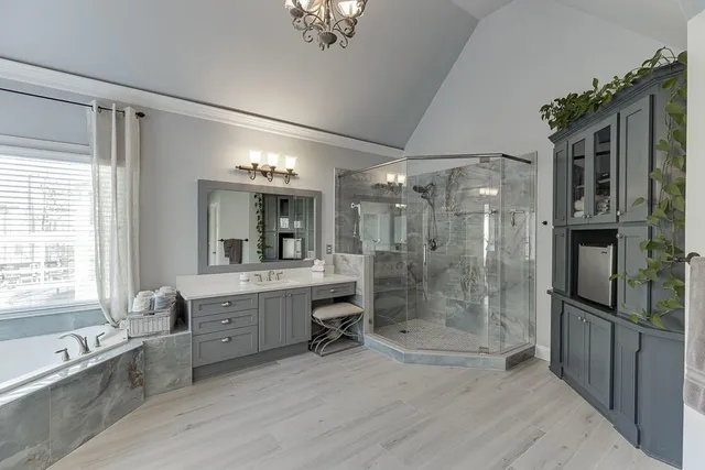 an aerial view of a house with swimming pool and outdoor seating