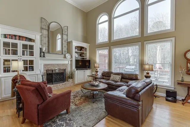 a living room with furniture a ceiling fan and a rug