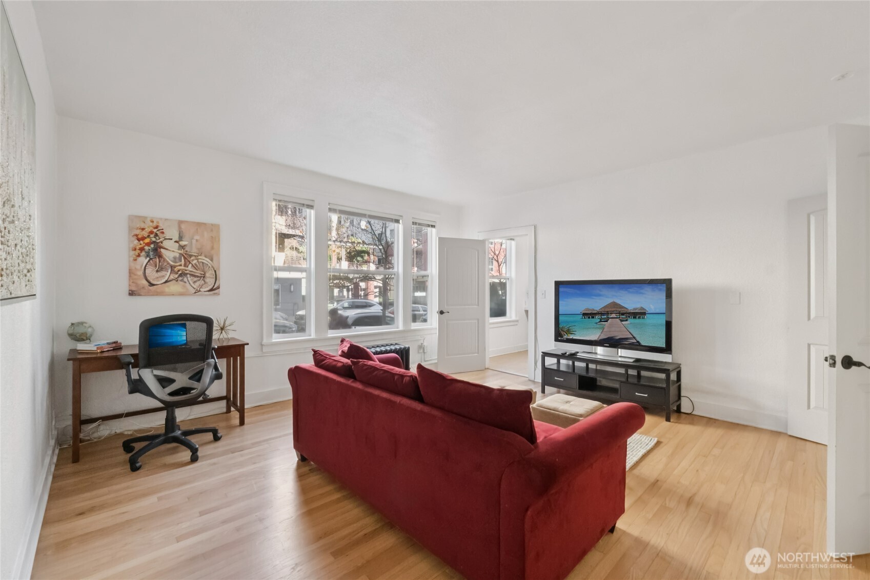 905 Northeast 43rd Street, Unit 108 Seattle, WA 98105 - Photo 12 of 28 a living room with furniture a flat screen tv and a fireplace