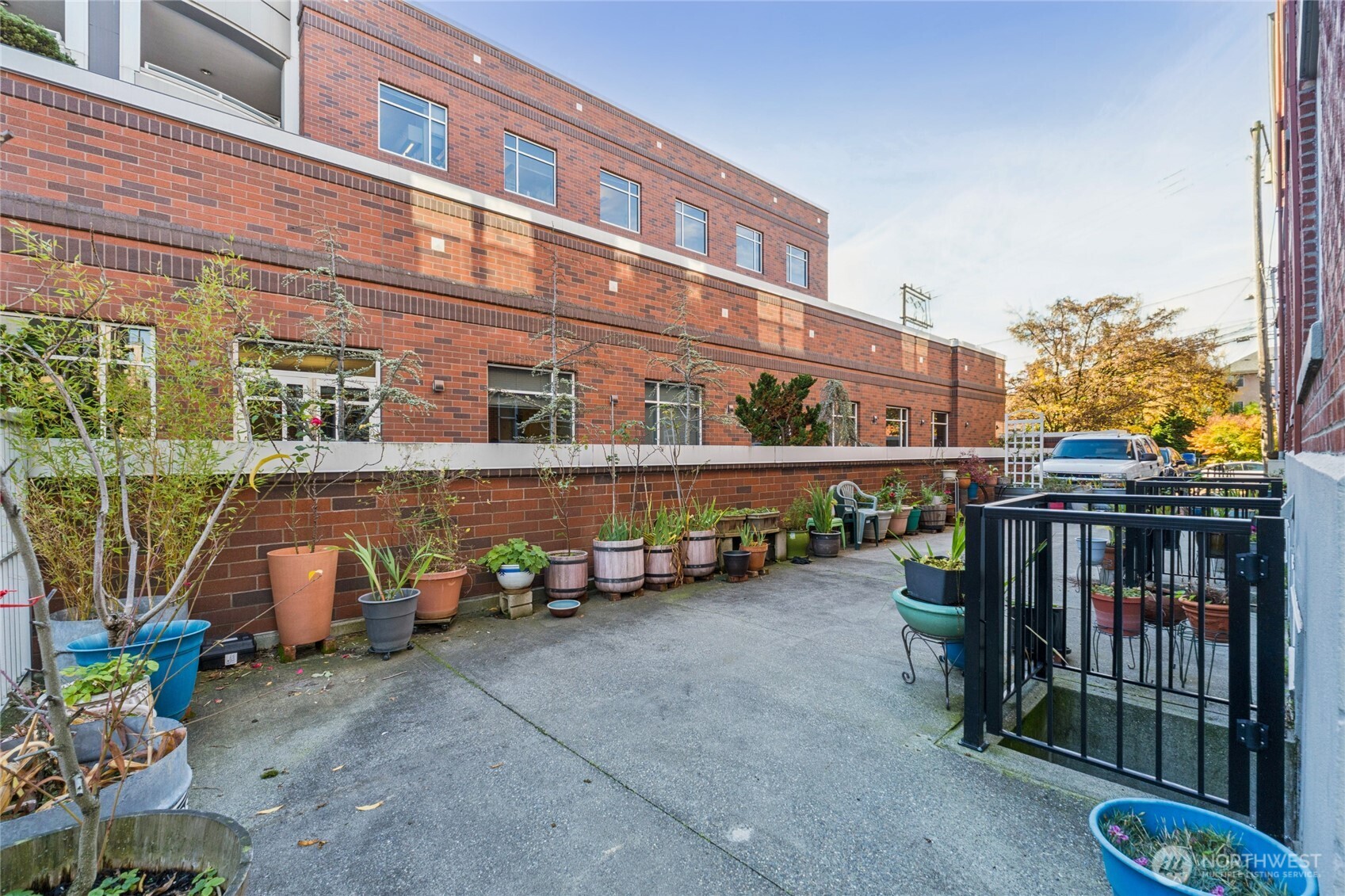 905 Northeast 43rd Street, Unit 108 Seattle, WA 98105 - Photo 19 of 28 a view of a blue house with large windows