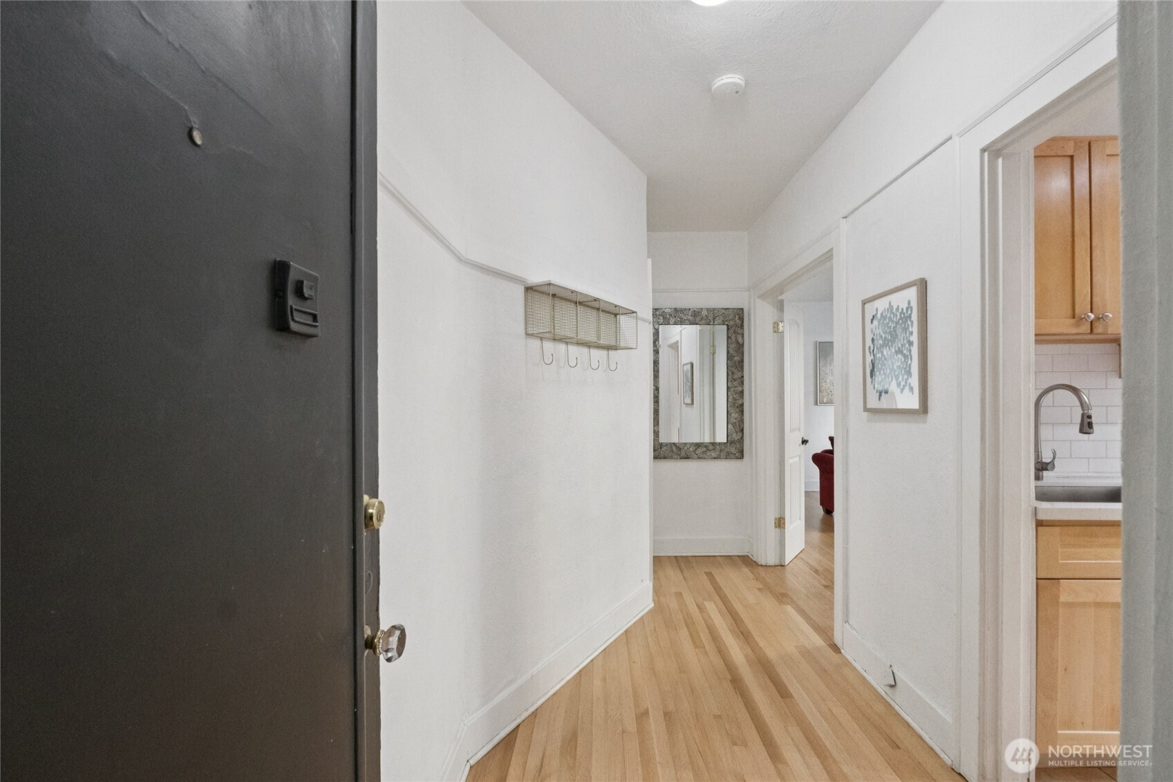 905 Northeast 43rd Street, Unit 108 Seattle, WA 98105 - Photo 6 of 28 a view of a hallway with wooden floor and closet