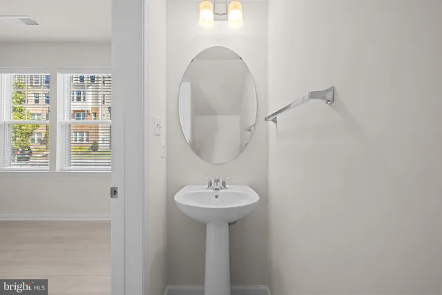 a bathroom with a sink a mirror and a window