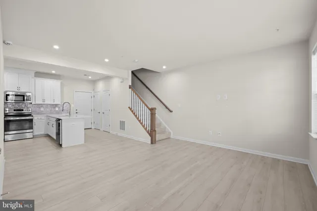 a view of kitchen with furniture and wooden floor