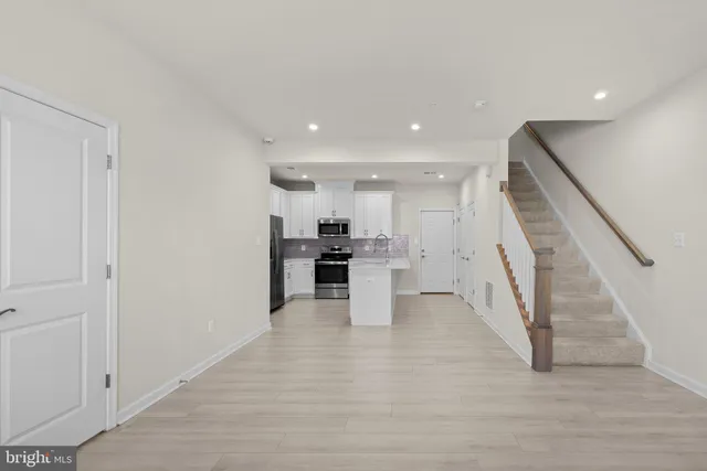 a view of kitchen with furniture and wooden floor