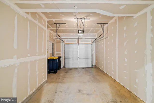 a front view of a building with a garden and plants