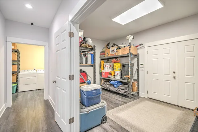 a kitchen with stainless steel appliances cabinets and a wooden floor