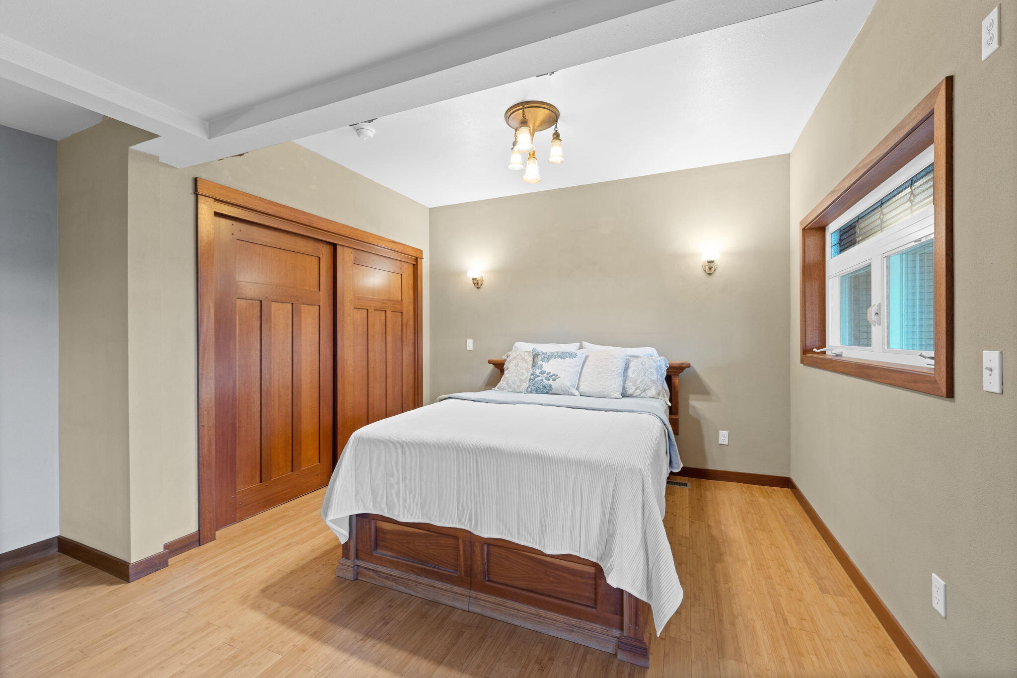 21925 Bear Creek Road Bend, OR 97702 - Photo 35 of 104 a bedroom with a bed and wooden floor