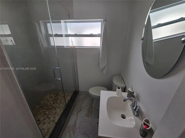 a bathroom with a sink and mirror