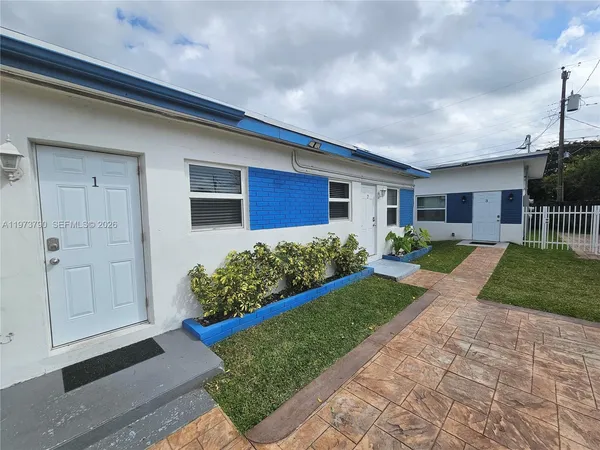 a front view of house with yard and outdoor seating