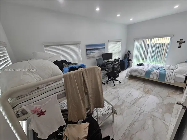 a bedroom with furniture and a window