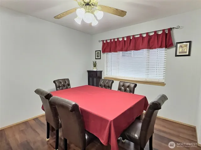 a dining room with a wooden table and chairs