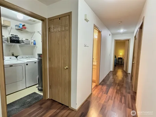 a view of hallway with wooden floor