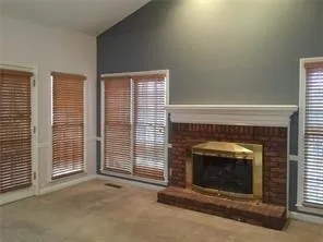 a view of an empty room with a fireplace