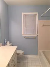 a bathroom with a toilet a sink a vanity and mirror