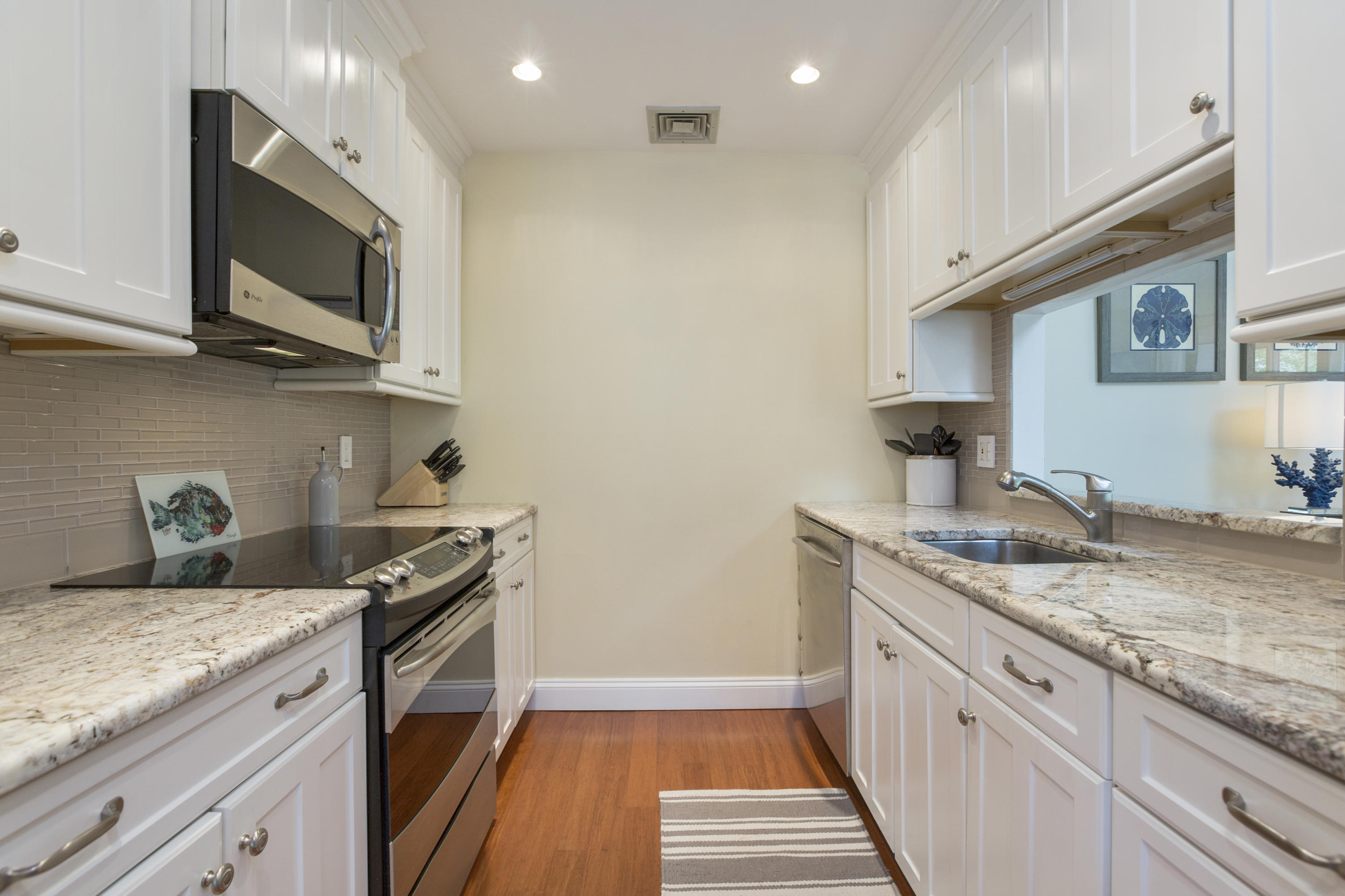 39 Hale Lane Darien, CT 06820 - Photo 8 of 19 a kitchen with granite countertop stainless steel appliances a sink a stove top oven a counter space and cabinets