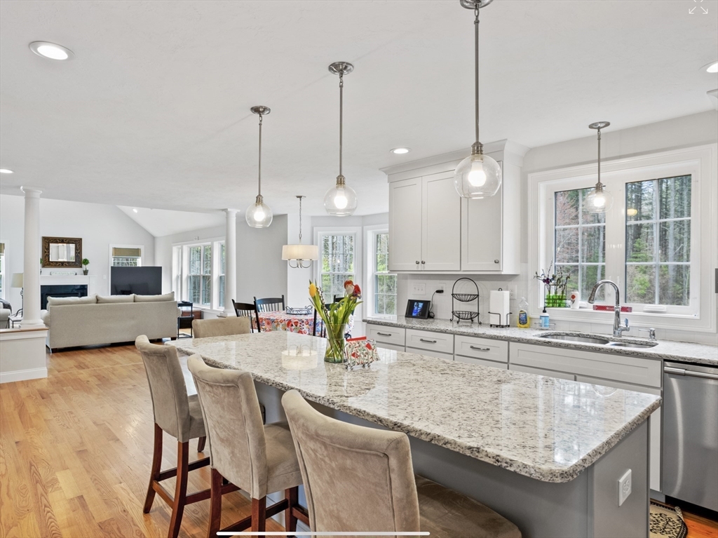 3 Pond Circle Pepperell, MA 01463 - Photo 11 of 33 a kitchen with granite countertop a sink a counter top space and living room view