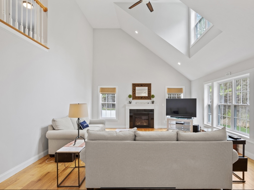 3 Pond Circle Pepperell, MA 01463 - Photo 15 of 33 a living room with furniture fireplace and a flat screen tv