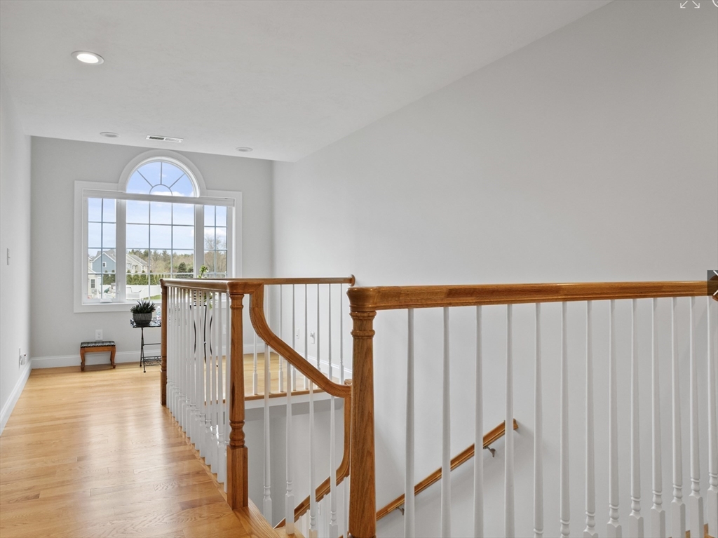 3 Pond Circle Pepperell, MA 01463 - Photo 18 of 33 a view of a hallway with wooden floor and staircase