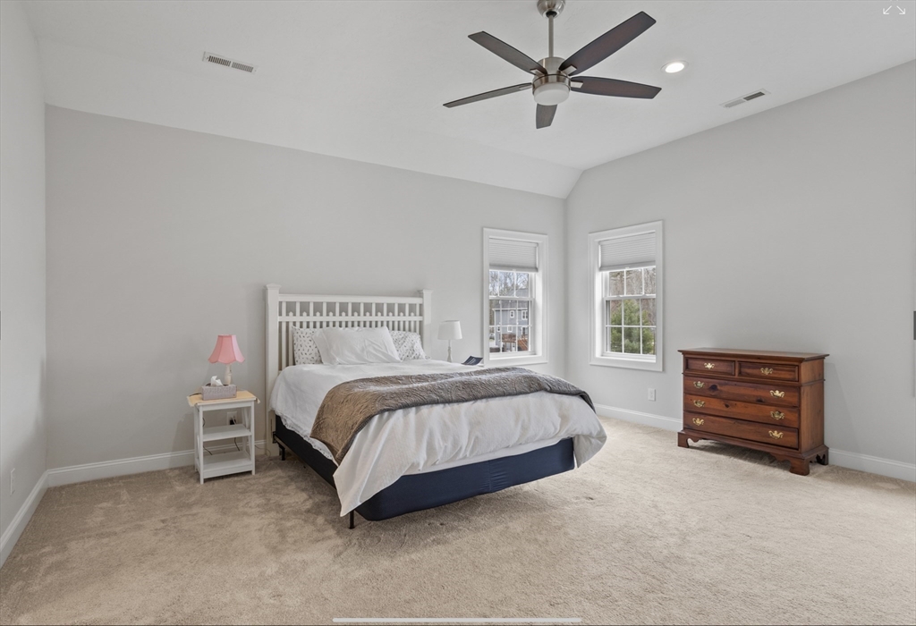 3 Pond Circle Pepperell, MA 01463 - Photo 20 of 33 a spacious bedroom with a bed and a ceiling fan