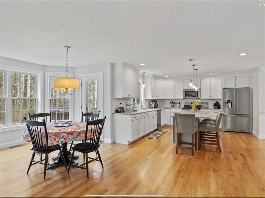 3 Pond Circle Pepperell, MA 01463 - Photo 9 of 33 a view of a dining room with furniture window and wooden floor