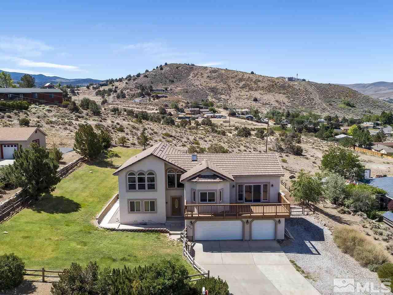 1090 Reese Way Reno, NV 89521 - Photo 1 of 33 a house with a garden in the background