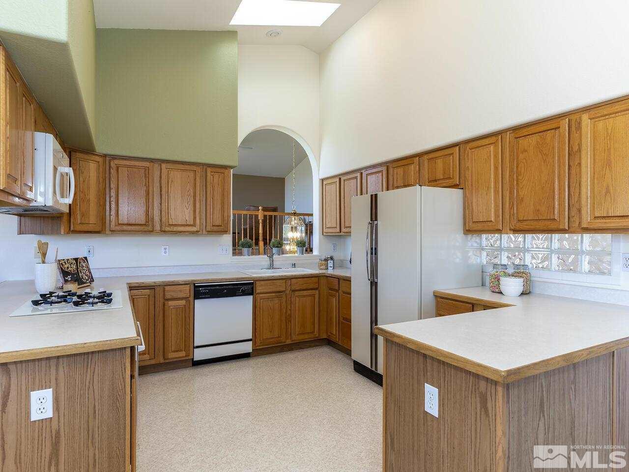 1090 Reese Way Reno, NV 89521 - Photo 17 of 33 a kitchen with refrigerator and cabinets