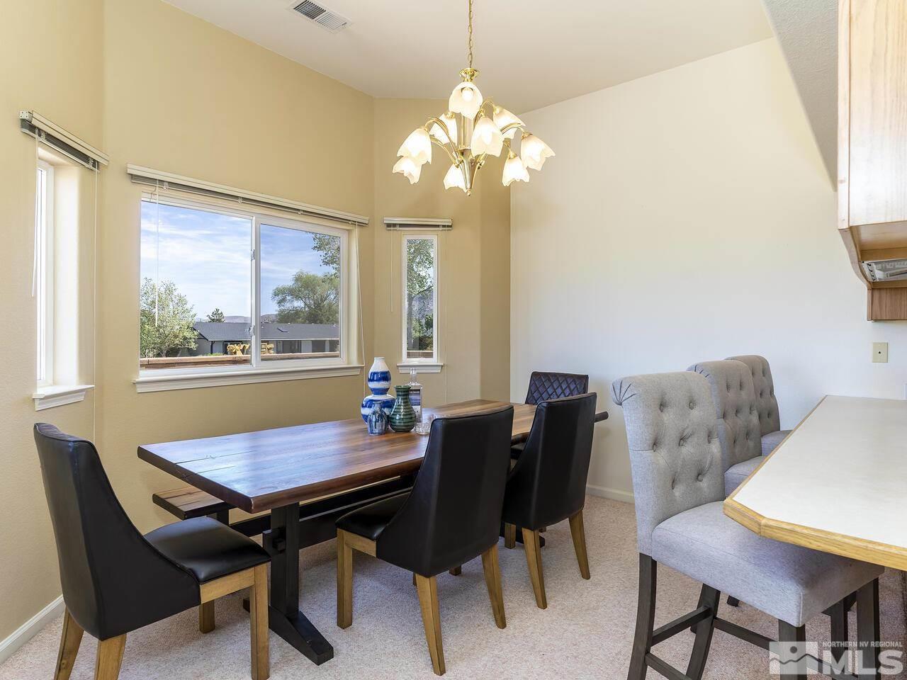 1090 Reese Way Reno, NV 89521 - Photo 18 of 33 a view of a dining room with furniture and a chandelier