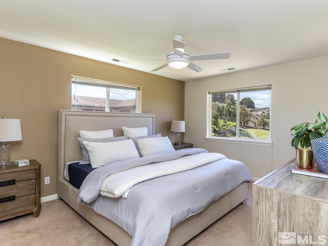 1090 Reese Way Reno, NV 89521 - Photo 19 of 33 a bedroom with a large bed and a window