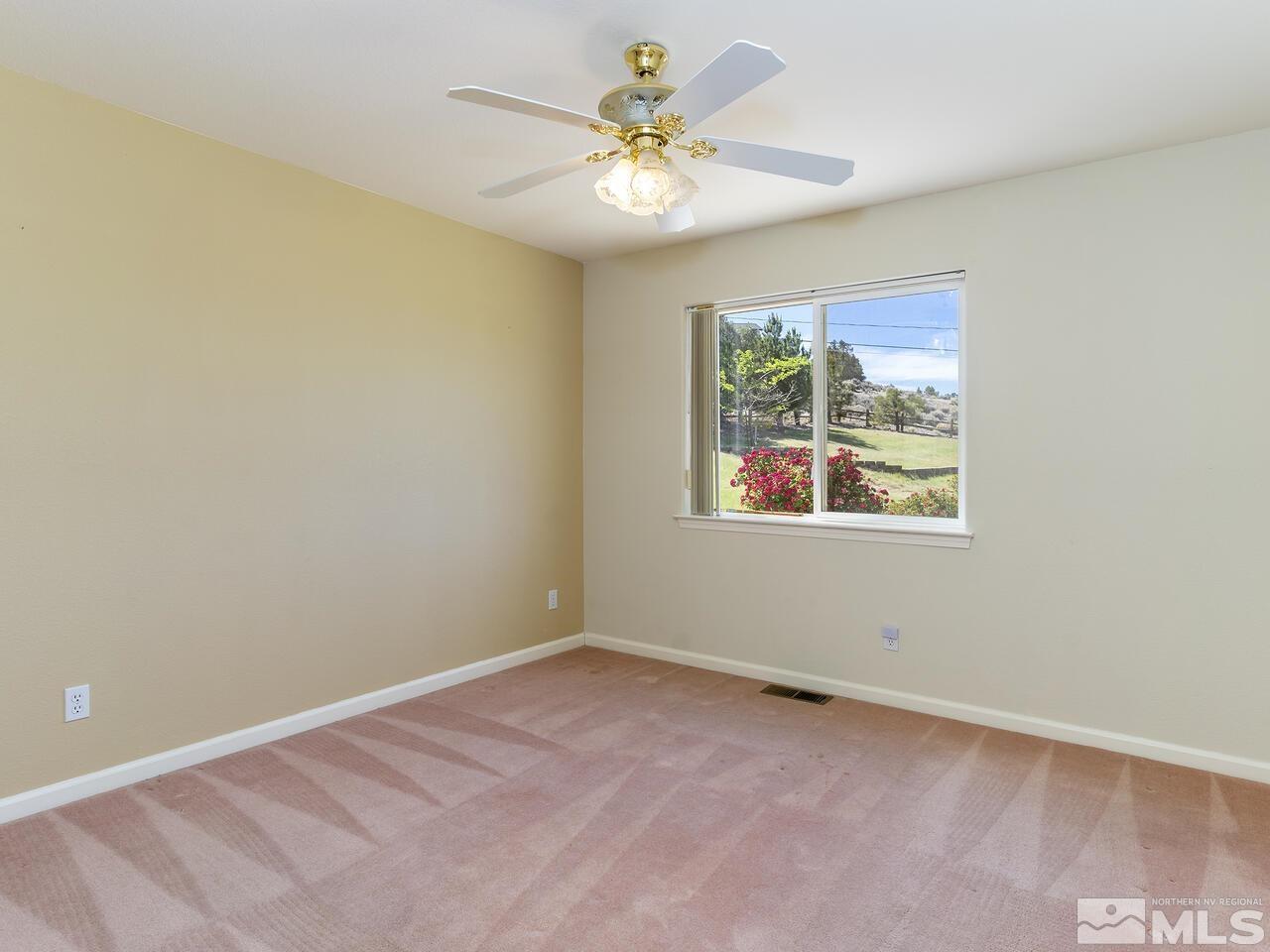 1090 Reese Way Reno, NV 89521 - Photo 23 of 33 a view of an empty room with window and a ceiling fan